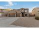 Two-story house with three car garage and desert landscaping at 11867 W Grant St, Avondale, AZ 85323