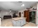 Open kitchen with granite island and wood shutters at 11867 W Grant St, Avondale, AZ 85323