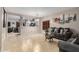 Open living room with view of kitchen and gray couches at 11867 W Grant St, Avondale, AZ 85323