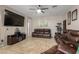 Living area with brown reclining sofas and large flat-screen TV at 11867 W Grant St, Avondale, AZ 85323