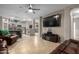 Open concept living area with kitchen view and large TV at 11867 W Grant St, Avondale, AZ 85323
