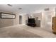Spacious loft area with carpet and a large TV at 11867 W Grant St, Avondale, AZ 85323