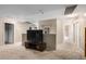 Spacious loft area with carpet and a large TV at 11867 W Grant St, Avondale, AZ 85323