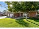 House exterior featuring a brick facade, two-car garage, and lush lawn at 12016 N 65Th Ave, Glendale, AZ 85304