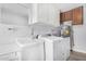 Bright laundry room with a washer, dryer, and ample storage at 13036 W Beardsley Rd, Sun City West, AZ 85375