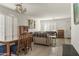 Dining area adjacent to the living room with a wooden table and chairs at 1330 S 219Th Dr, Buckeye, AZ 85326