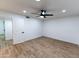 Light and airy bedroom with wood-look tile floors and ceiling fan at 13837 N Tumblebrook Way, Sun City, AZ 85351