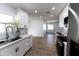 Updated kitchen with white cabinets, quartz countertops, and stainless steel appliances at 13837 N Tumblebrook Way, Sun City, AZ 85351