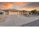 Front view of a single-story house with a two-car garage and well-maintained landscaping at 14313 W Circle Ridge Dr, Sun City West, AZ 85375