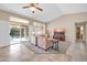 Bright and airy living room with tile floors and sliding glass doors to a patio at 14757 W Pinchot Ct, Goodyear, AZ 85395