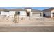 Single-story home with a two-car garage and desert landscaping at 15426 W Cottontail Ln, Surprise, AZ 85387