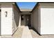 Inviting entryway with a gray door and light-colored stone walls at 15656 W Mercer Ln, Surprise, AZ 85379