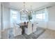 Elegant dining room with a large table, chandelier, and patterned wallpaper at 15659 W Mercer Ln, Surprise, AZ 85379