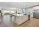 Modern kitchen with a large island, white cabinets, and stainless steel appliances at 15659 W Mercer Ln, Surprise, AZ 85379