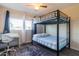 Bright bedroom with a bunk bed, desk, and window at 17621 N 18Th Dr, Phoenix, AZ 85023