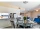 Glass dining table with four chairs, situated near kitchen at 17621 N 18Th Dr, Phoenix, AZ 85023