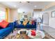 Bright living room with comfy blue sofa and view into kitchen at 17621 N 18Th Dr, Phoenix, AZ 85023