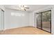 Spacious bedroom with wood floors, ceiling fan, and private balcony access at 2228 N 52Nd St # 240, Phoenix, AZ 85008