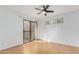 Bedroom with wood floors, ceiling fan, and private balcony access at 2228 N 52Nd St # 240, Phoenix, AZ 85008