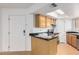 Kitchen with wood cabinets, black countertops, and appliances at 2228 N 52Nd St # 240, Phoenix, AZ 85008