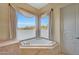 Relaxing bathroom with a corner soaking tub and large windows providing natural light at 24200 N Alma School Rd # 2, Scottsdale, AZ 85255