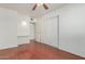 Bedroom with wood floors, built-in shelving and a sliding door at 2923 W Wethersfield Rd, Phoenix, AZ 85029