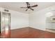 Bright bedroom with wood floors, ceiling fan, and access to bathroom at 2923 W Wethersfield Rd, Phoenix, AZ 85029