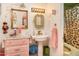 Retro-style bathroom with a pedestal sink and pink vanity at 4819 W Chicago St, Chandler, AZ 85226