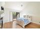 Main bedroom with hardwood floors, fireplace, and access to balcony at 7272 E Gainey Ranch Rd # 91, Scottsdale, AZ 85258