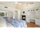 Bright bedroom with fireplace and built-in desk at 7272 E Gainey Ranch Rd # 91, Scottsdale, AZ 85258