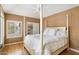 Bedroom with a four-poster bed and wood floors at 7272 E Gainey Ranch Rd # 91, Scottsdale, AZ 85258