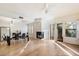 Open dining room with hardwood floors, fireplace, and access to patio at 7272 E Gainey Ranch Rd # 91, Scottsdale, AZ 85258