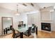 Elegant dining area with glass table and fireplace at 7272 E Gainey Ranch Rd # 91, Scottsdale, AZ 85258