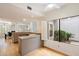 Kitchen with breakfast bar, granite counters, and view to dining area at 7272 E Gainey Ranch Rd # 91, Scottsdale, AZ 85258