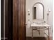 Charming bathroom with marble vanity and arched mirror at 8145 N 68Th St, Paradise Valley, AZ 85253