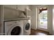 Laundry room with washer, dryer, built-in cabinets, and a view of the pool at 8145 N 68Th St, Paradise Valley, AZ 85253