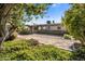Landscaped backyard with gravel pathway and mature shrubs at 1008 W Amelia Ave, Phoenix, AZ 85013