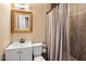 Clean bathroom with white vanity, shower, and gold framed mirror at 1008 W Amelia Ave, Phoenix, AZ 85013