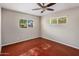 Spacious bedroom with ceiling fan and reddish-brown floor at 1008 W Amelia Ave, Phoenix, AZ 85013
