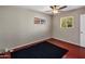 Well-lit bedroom with ceiling fan and dark carpet at 1008 W Amelia Ave, Phoenix, AZ 85013