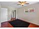 Bedroom with ceiling fan, dark carpet, and mirrored closet at 1008 W Amelia Ave, Phoenix, AZ 85013