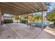 Backyard with covered patio, refreshing pool, and lush landscaping at 1008 W Amelia Ave, Phoenix, AZ 85013