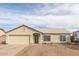 Single story house with two car garage and desert landscaping at 10246 W Catalina Dr, Arizona City, AZ 85123