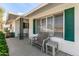 Relaxing front porch with bench and side chairs at 13023 W Skyview Dr, Sun City West, AZ 85375