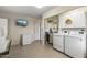 Laundry room features a washer, dryer, and ample storage space at 13023 W Skyview Dr, Sun City West, AZ 85375