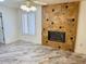 Living room with tile floors, fireplace and window at 13912 W Pavillion Dr, Sun City West, AZ 85375