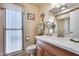 Bathroom features a single vanity with a quartz countertop and large mirror at 14437 N Boswell Blvd, Sun City, AZ 85351