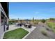 Outdoor patio with seating area, dining table, and artificial turf at 17608 E Desert Vista Trl, Rio Verde, AZ 85263