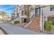 Front view of a modern townhouse with stairs leading to the entrance and attached garage at 17657 N 77Th Pl, Scottsdale, AZ 85255