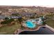 Aerial view of pool, clubhouse, and lake at 17957 W Fairview St, Goodyear, AZ 85338